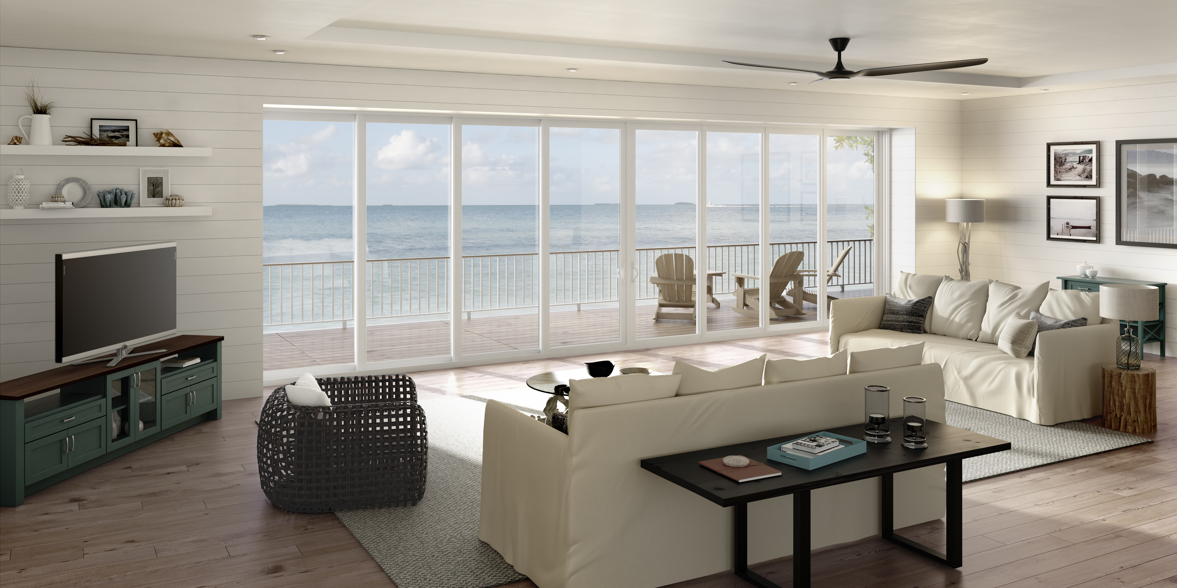 PGT SGD5570 multi-panel sliding glass doors spanning a beach home living room with an ocean view