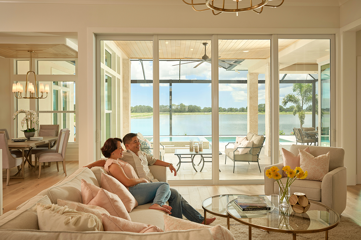 Couple sitting in quiet room with impact-resistant windows and doors