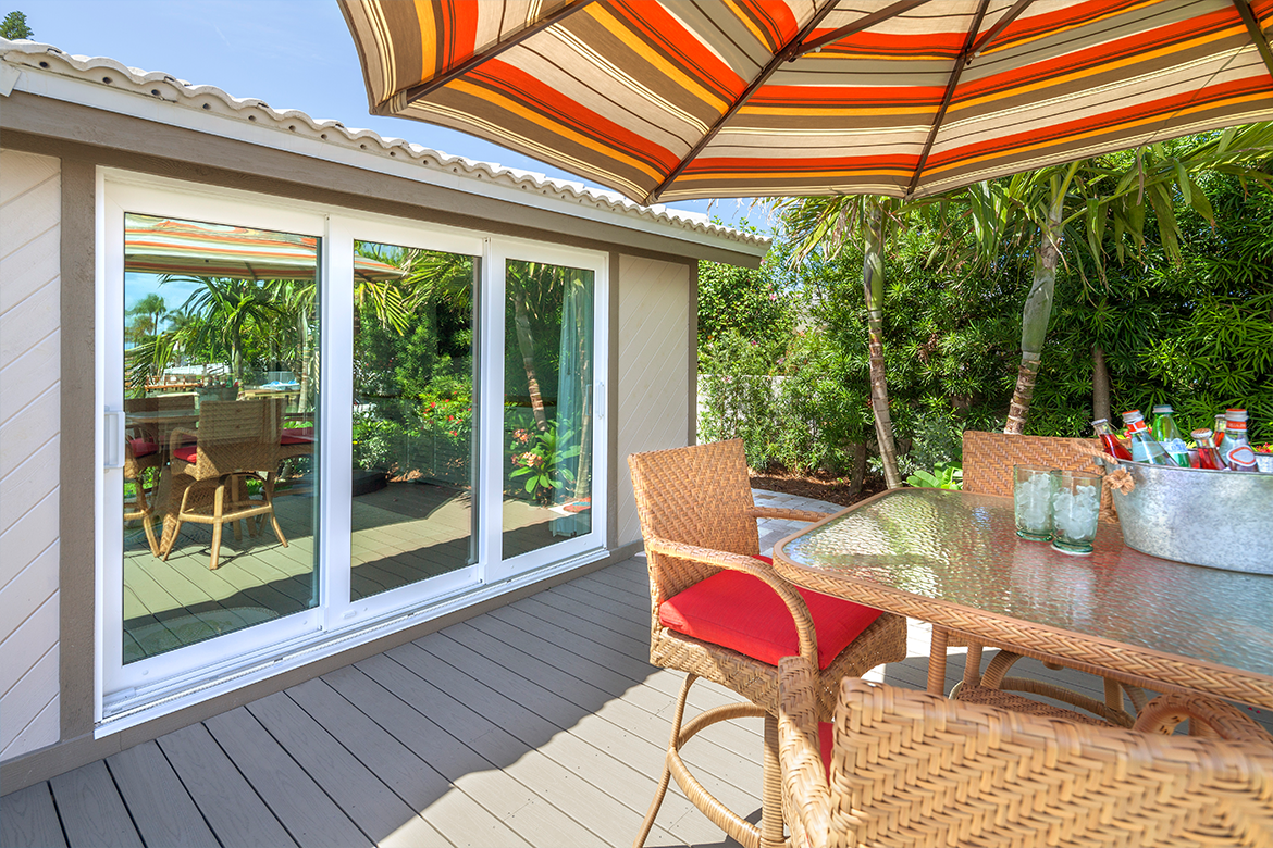 Poolside patio umbrella provides shade on the backyard deck