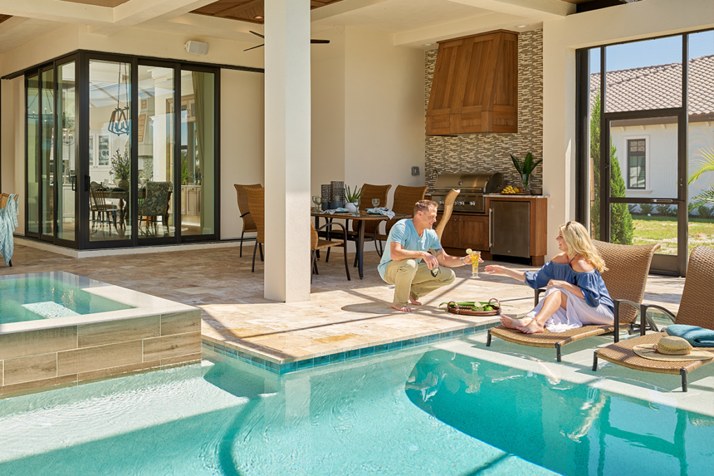 Couple enjoying their poolside patio with hurricane resistant windows