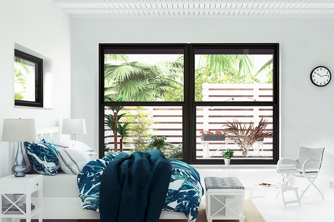 Vinyl windows in a coastal home bedroom.