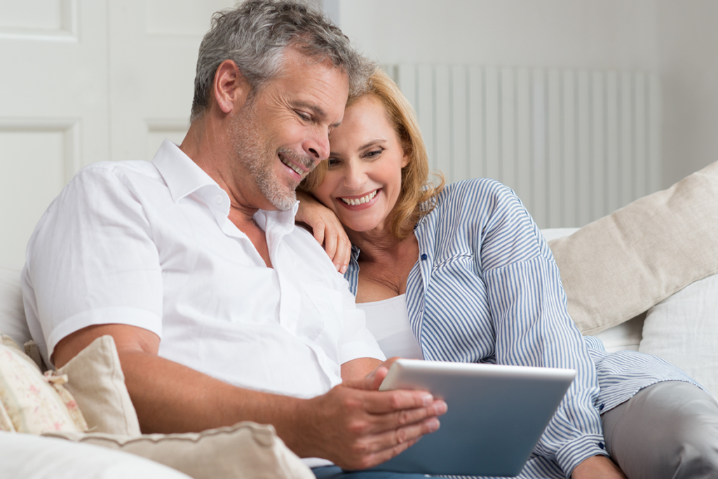 Middle-aged couple shopping for new vinyl or aluminum windows in their family home.