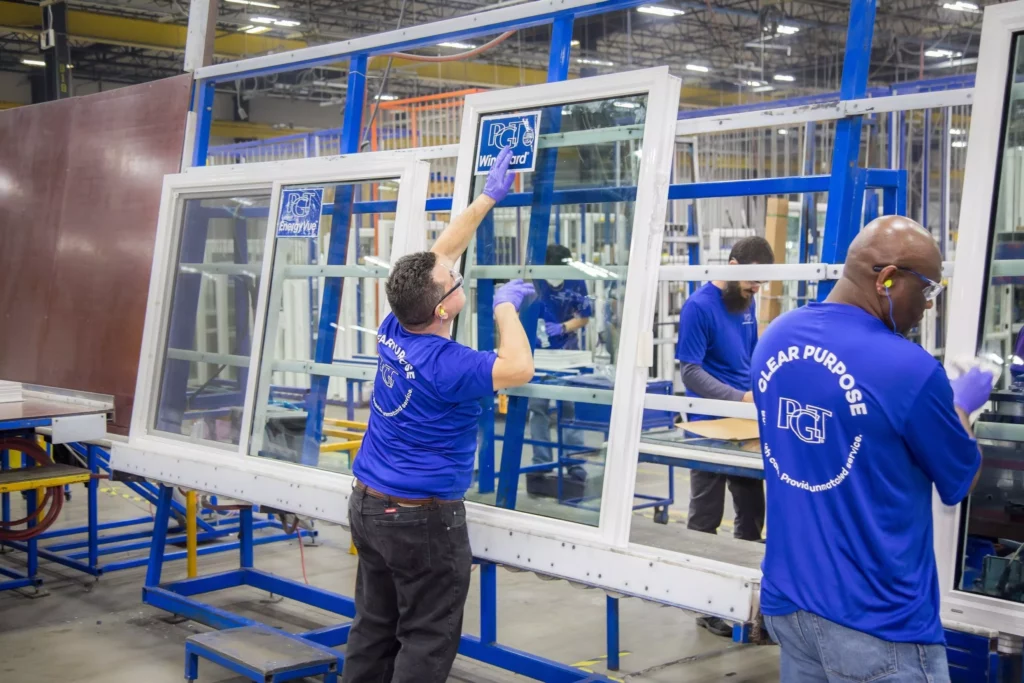 Factory floor workers inspecting windows